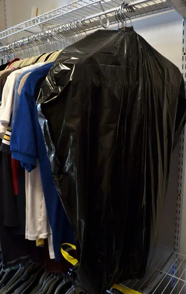 An easy way to move the clothes in your closet: wrap a trash bag