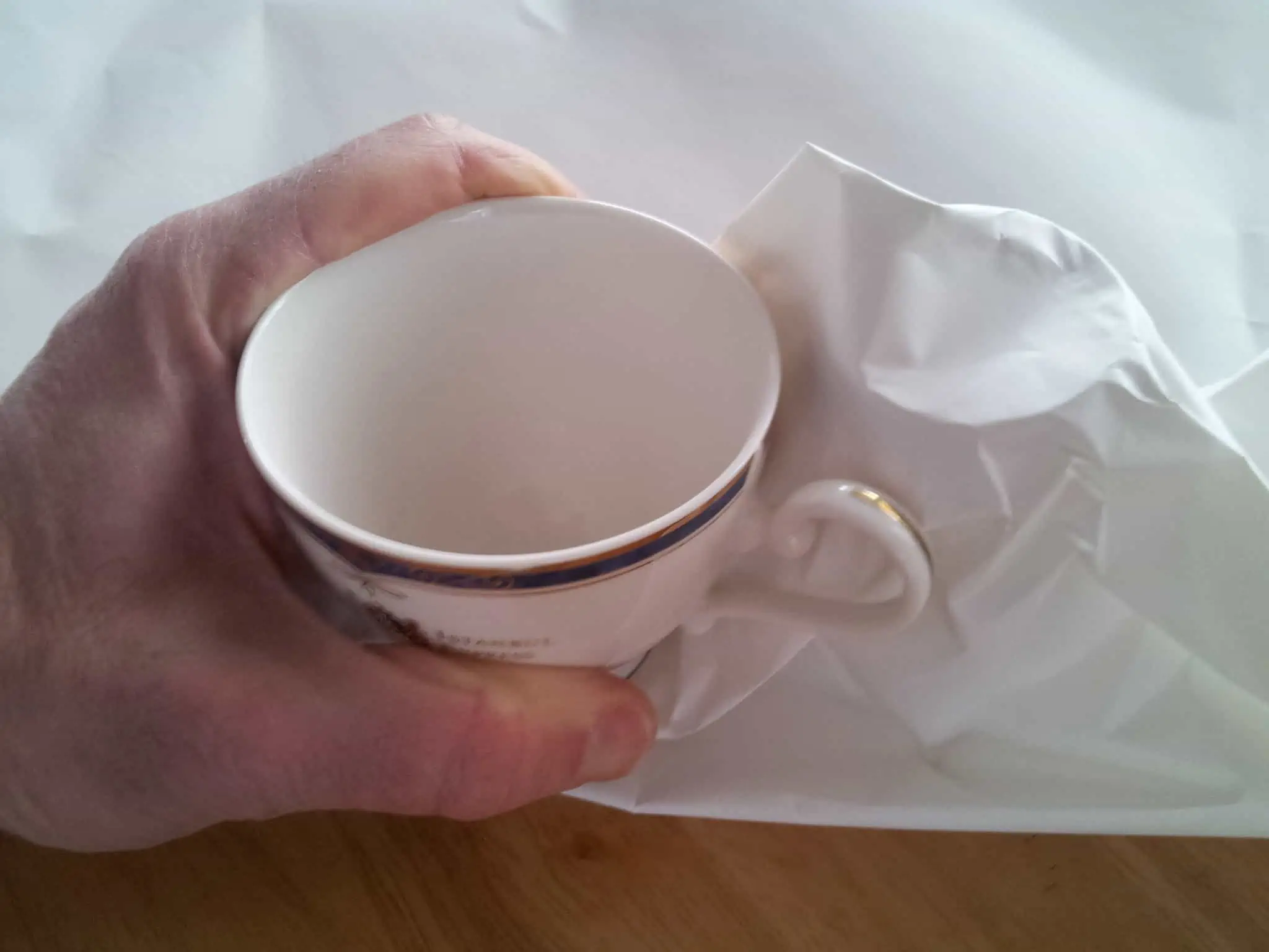 Photo of a Hand Packing Teacups Step 3