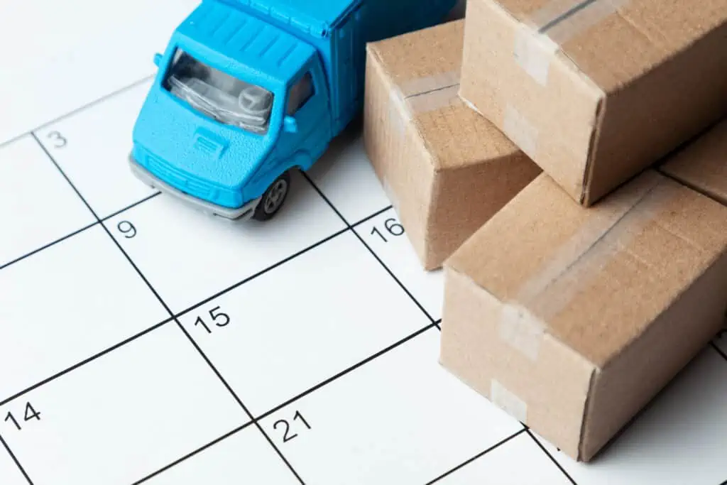 toy boxes and a truck sit on top of a calendar