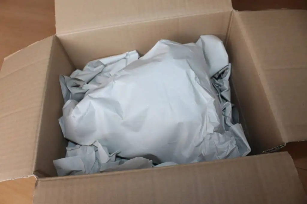 a lampshade packed and secured in a box
