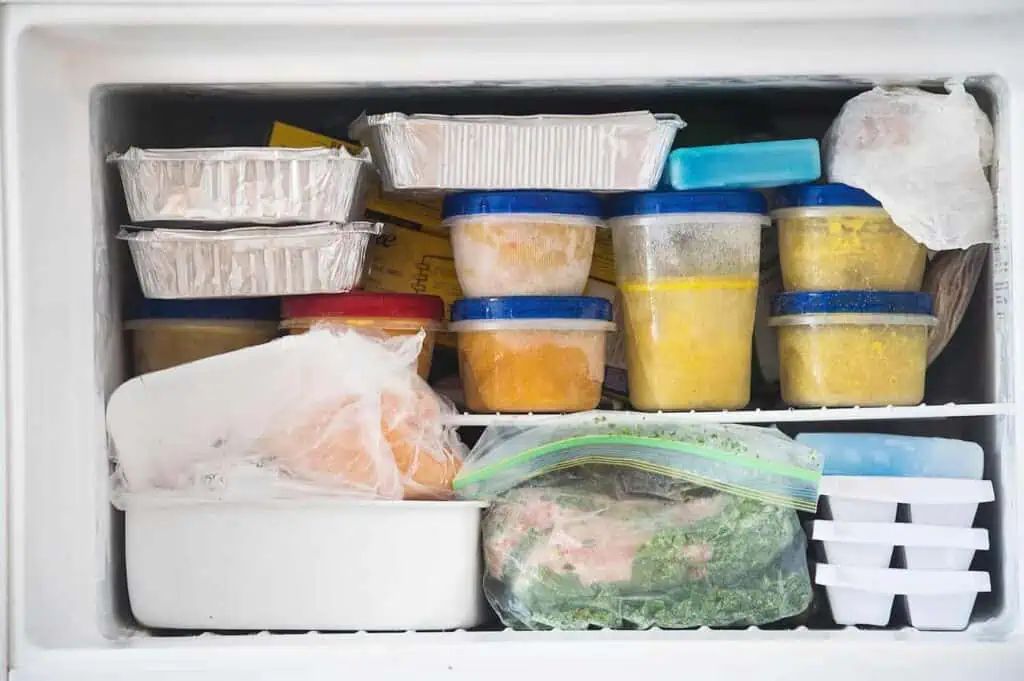 A freezer packed full of food in various containers