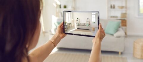a woman takes a photo of her living room