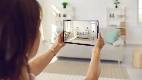 a woman takes a photo of her living room
