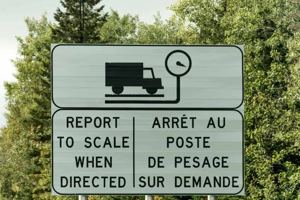 Sign for Trucking Weigh Station scale report weight on highway in Quebec Canada