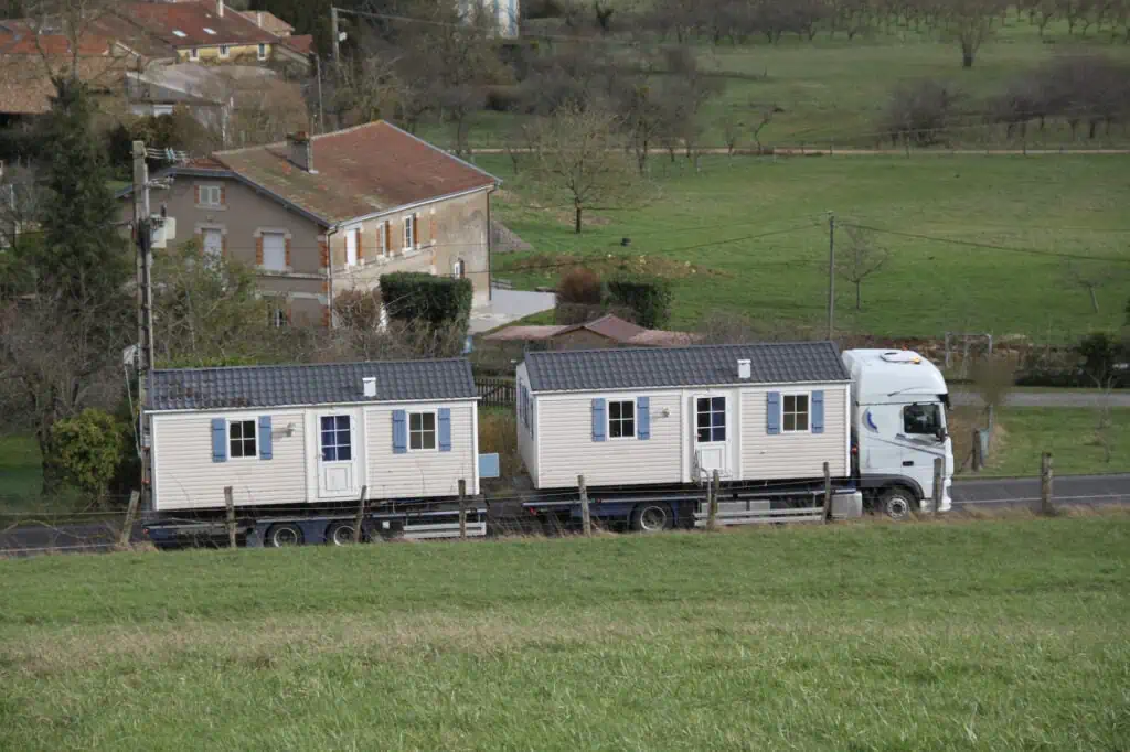 two mobile homes on a truck in a cross country move