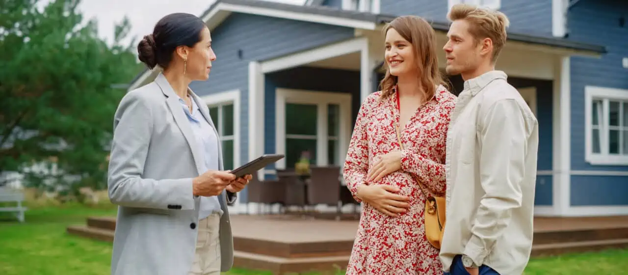 a house hunting pregnant couple speaks to a realtor