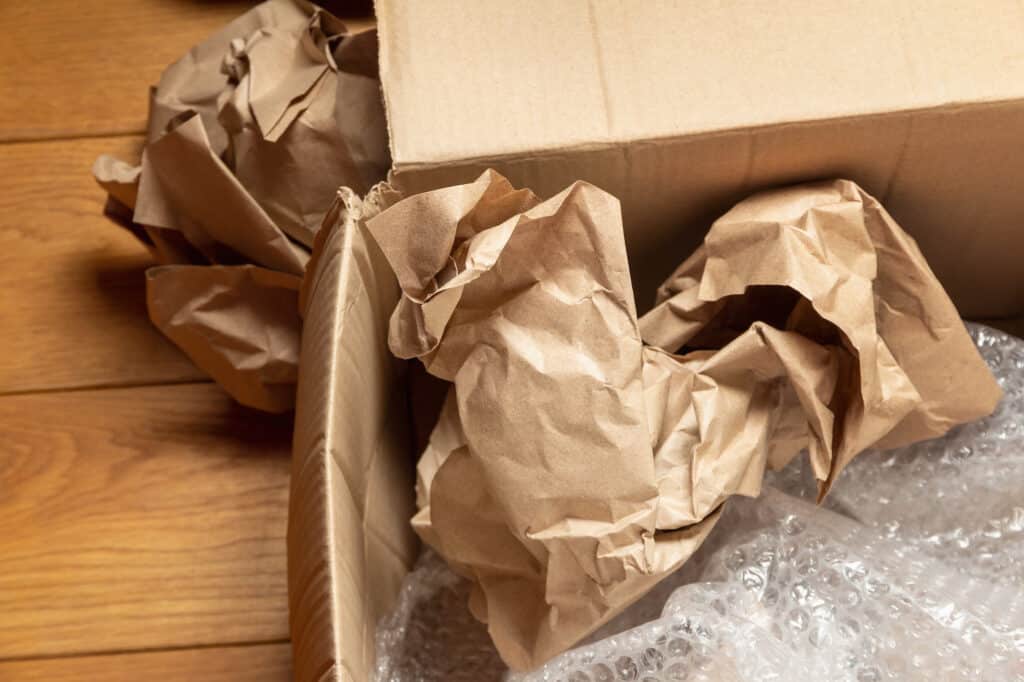 a moving box with packing paper in the gaps to protect its contents