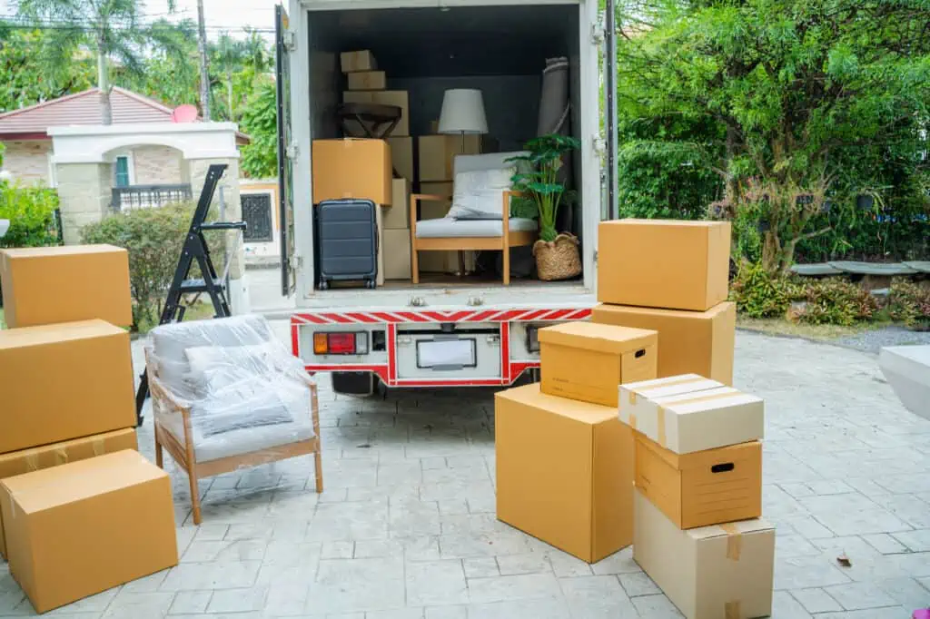 a moving truck being packed with furniture and boxes