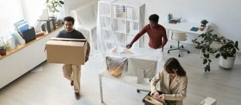 employees packing up and moving the items in their small business office