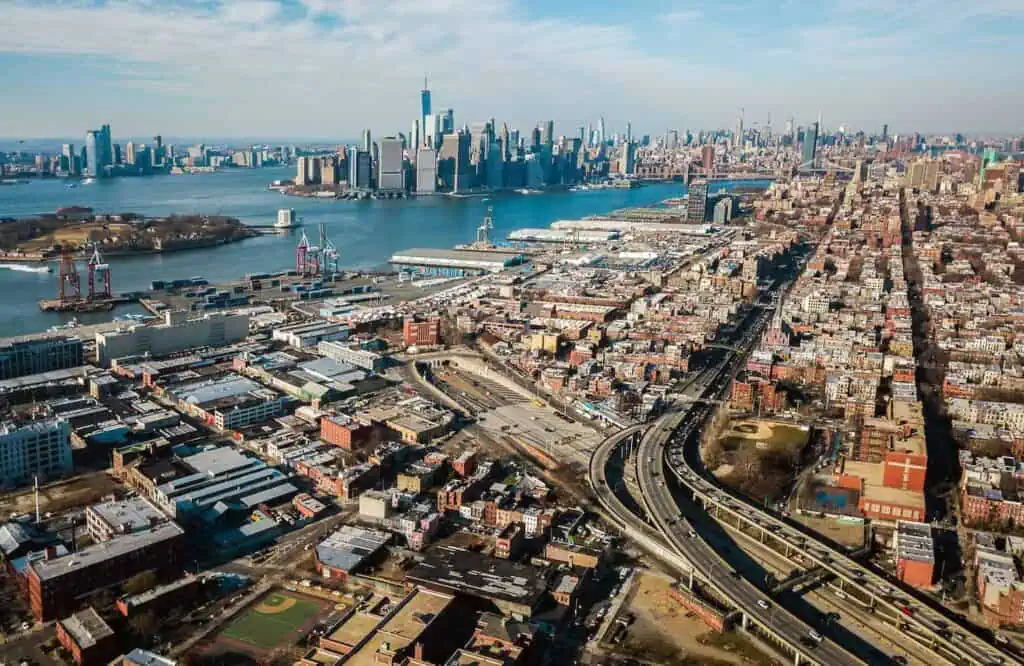 an overhead view of brooklyn. the downtown manhattan skyline can be seen across the water.