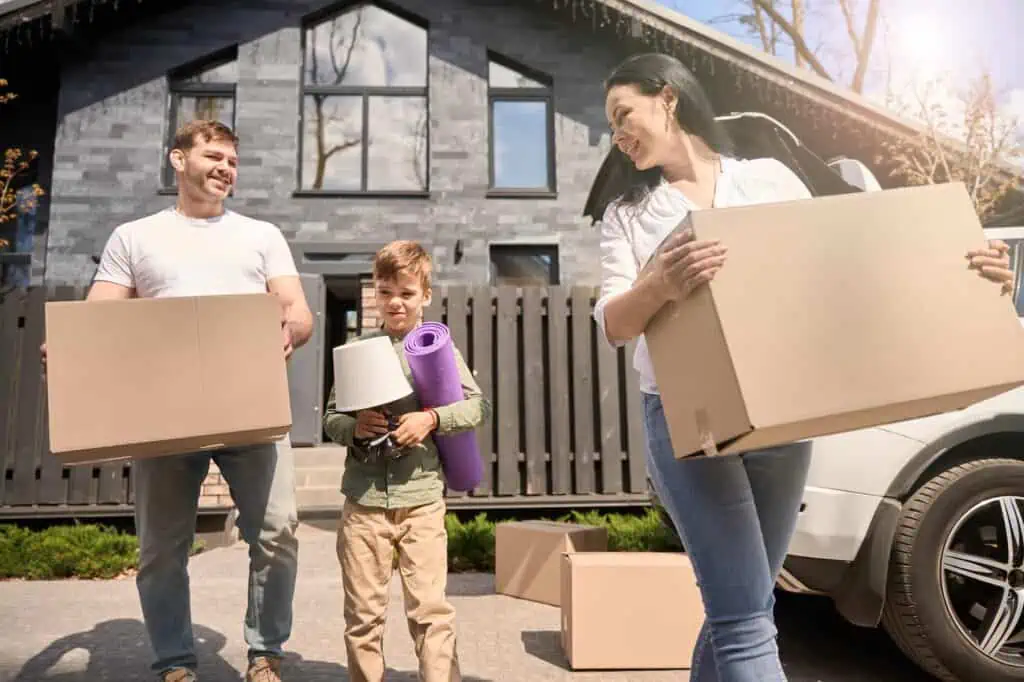 a family carries boxes out of a home