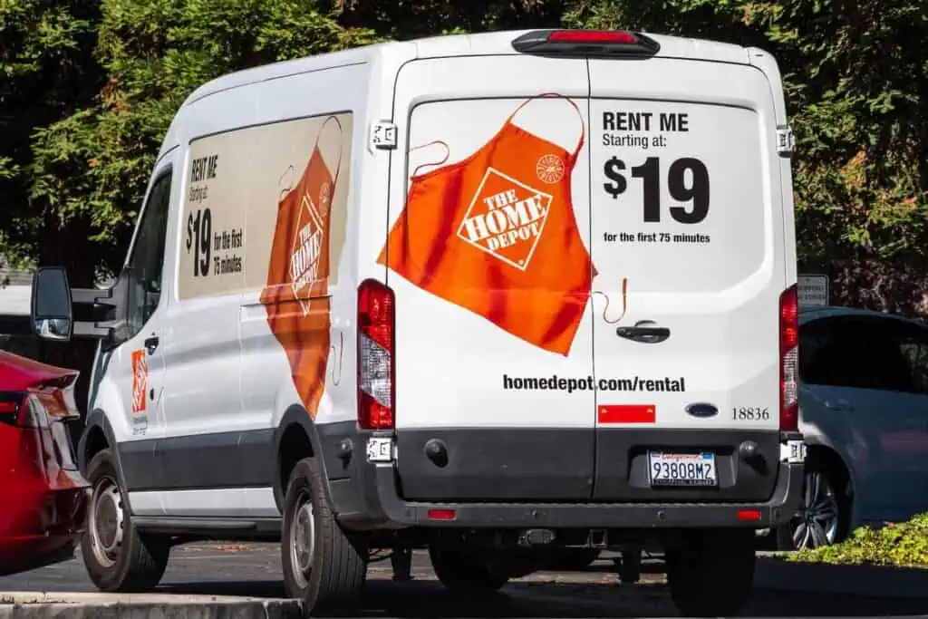 a home depot moving van parked on the side of the street