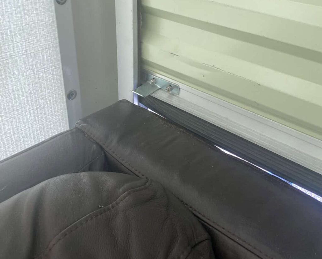A picture of a clip on a PODS door hitting the back of a couch