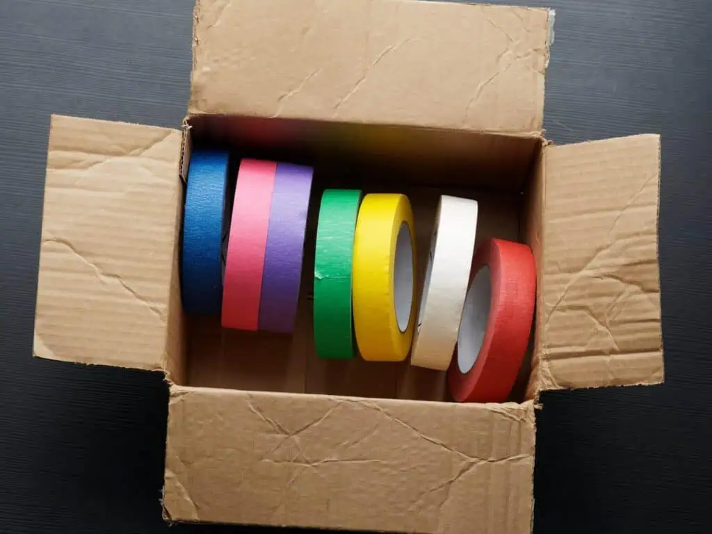 An array of colorful masking tape rolls in a box