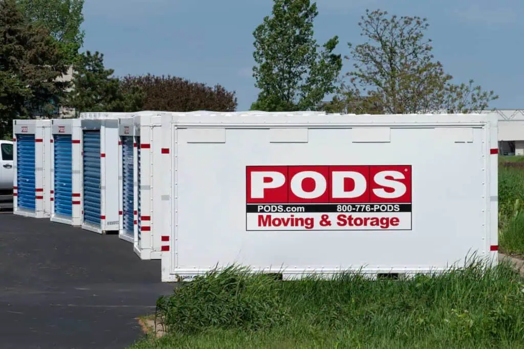 A row of PODS sits in a parking lot