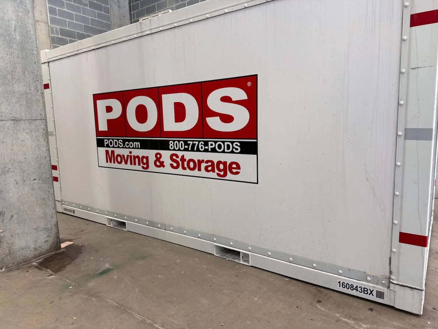 A PODS container is set in an area with a concrete floor