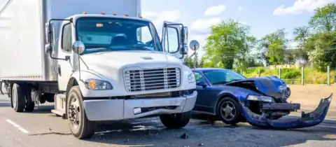 Damaged car and rental truck after a road accident.