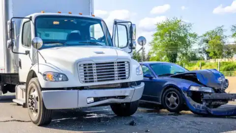 Damaged car and rental truck after a road accident.