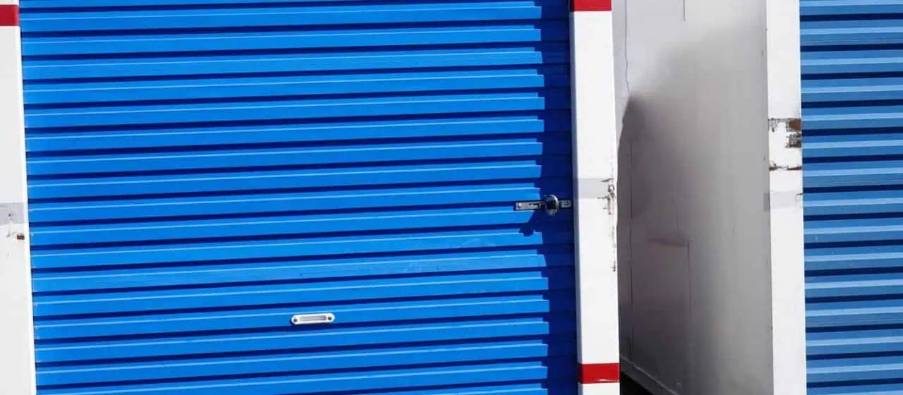 an image of two moving containers with blue doors set side by side