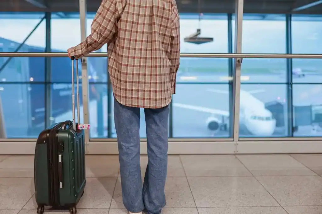 Someone carrying a camera case in the airport.