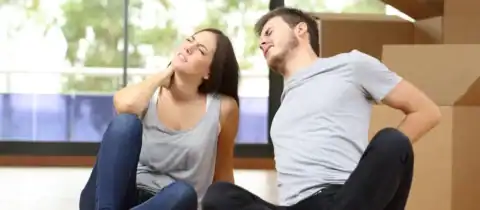 Couple with back and neck pain after lifting boxes during a move