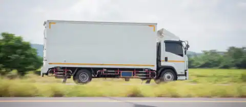 Moving truck driving on highway