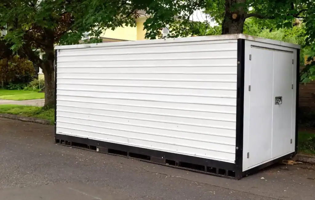 Portable moving container placed on driveway for loading household items