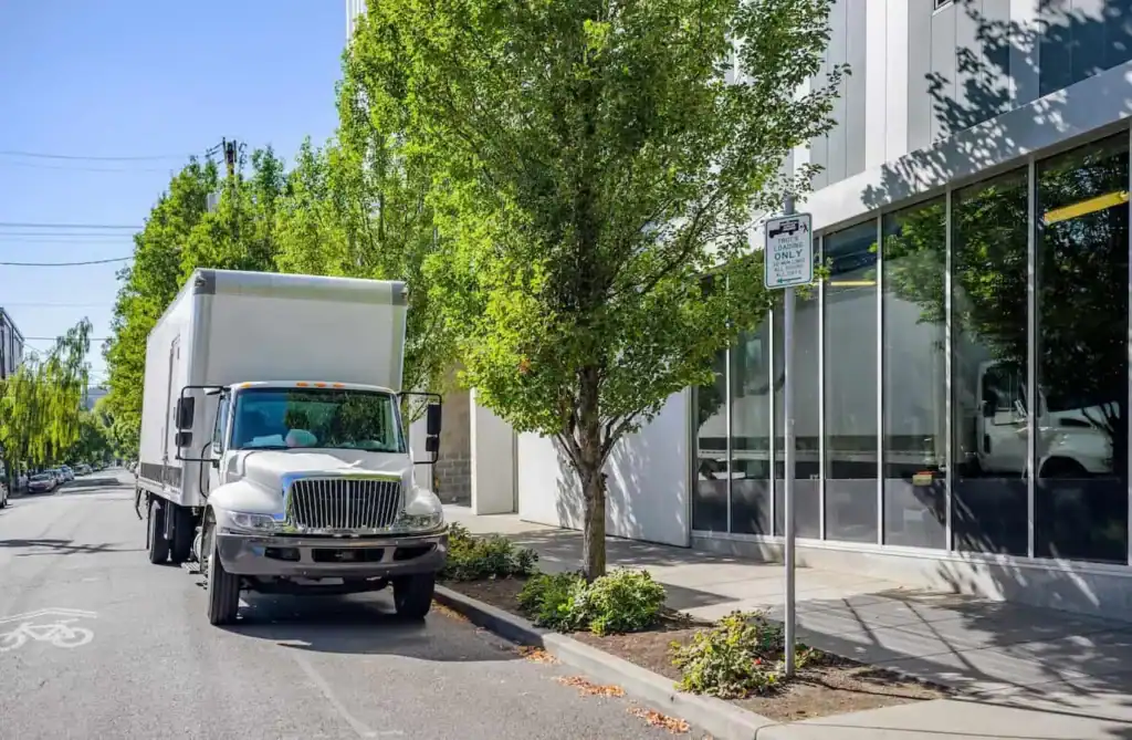 Moving truck parked on city street for unloading