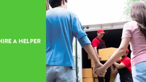HireAHelper movers helping a couple move boxes into a truck