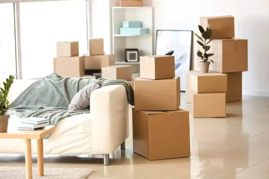 Packed boxes stacked in a modern living room, ready for a household move