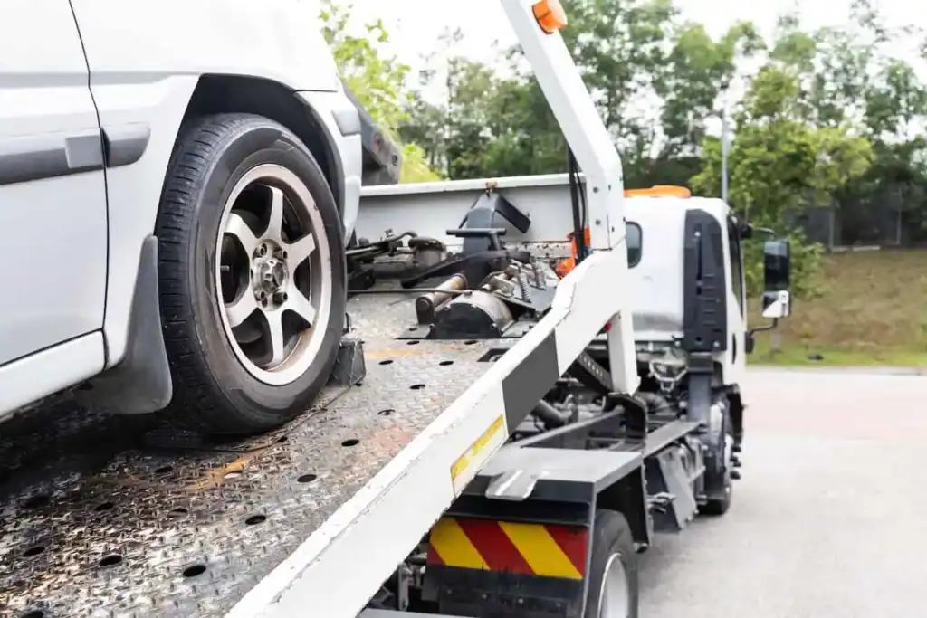 A tow truck providing roadside assistance to a broken-down car