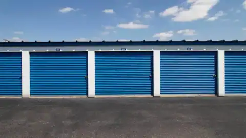 A row of self-storage units with blue doors