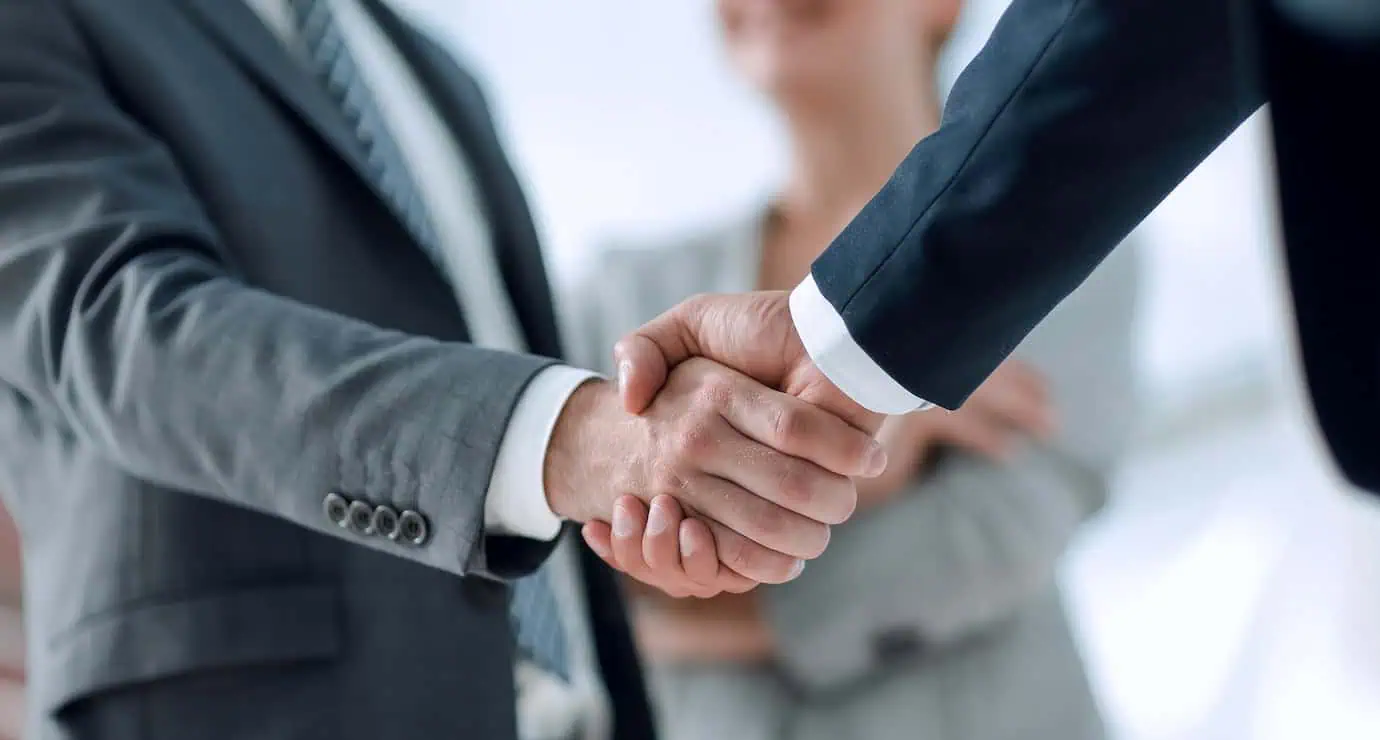 Close-up handshake between business professionals finalizing a service agreement