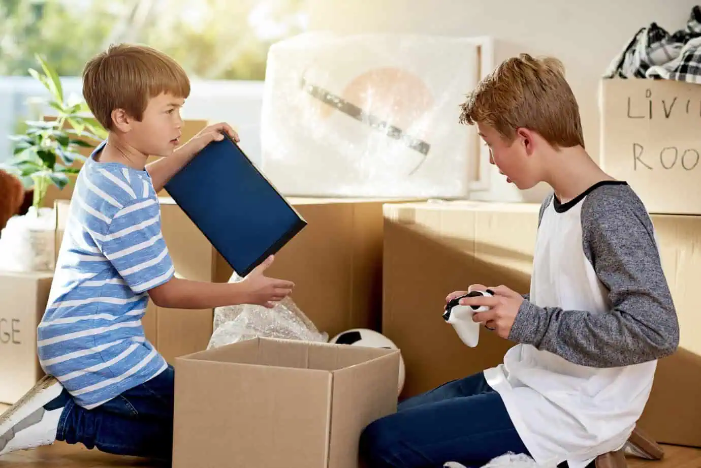 Brothers packing their room for a move