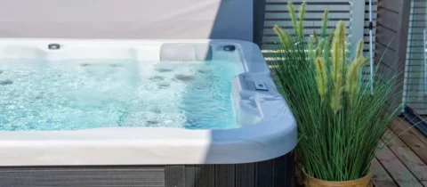 a hot tub set up on a backyard patio